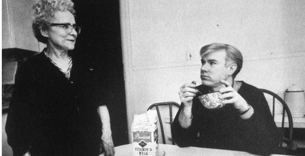 Andy Warhol eating cereal and looking at his mother, Julia